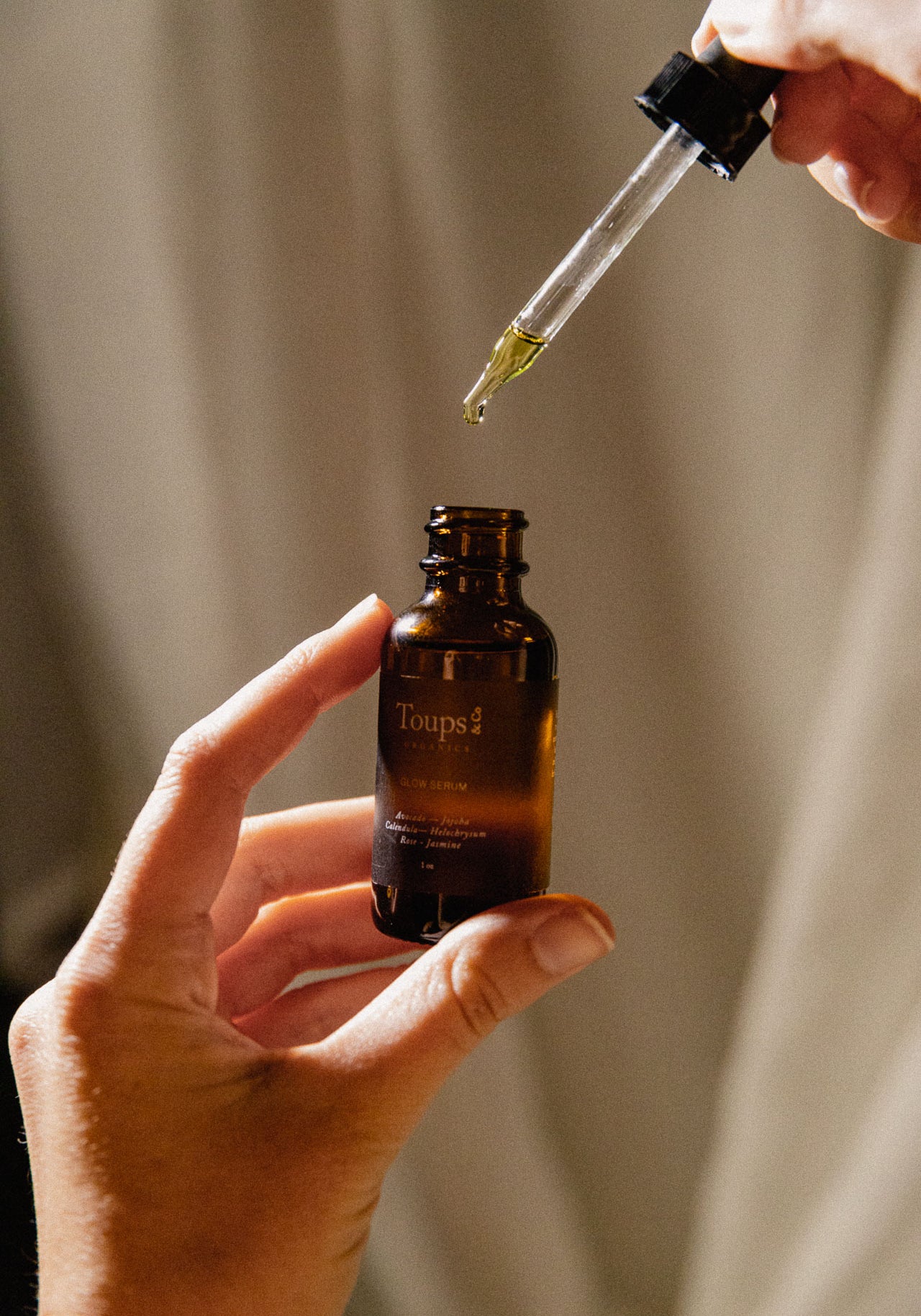 woman-pours-nontoxic-face-serum-into-bottle