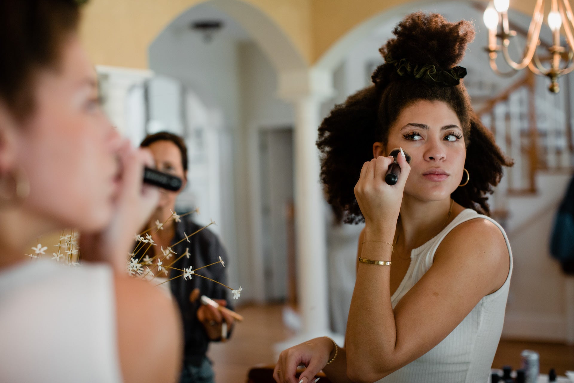 woman-applying-makeup-in-mirror