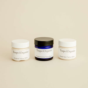 three-mini-tallow-balm-jars-displayed-with-beige-background