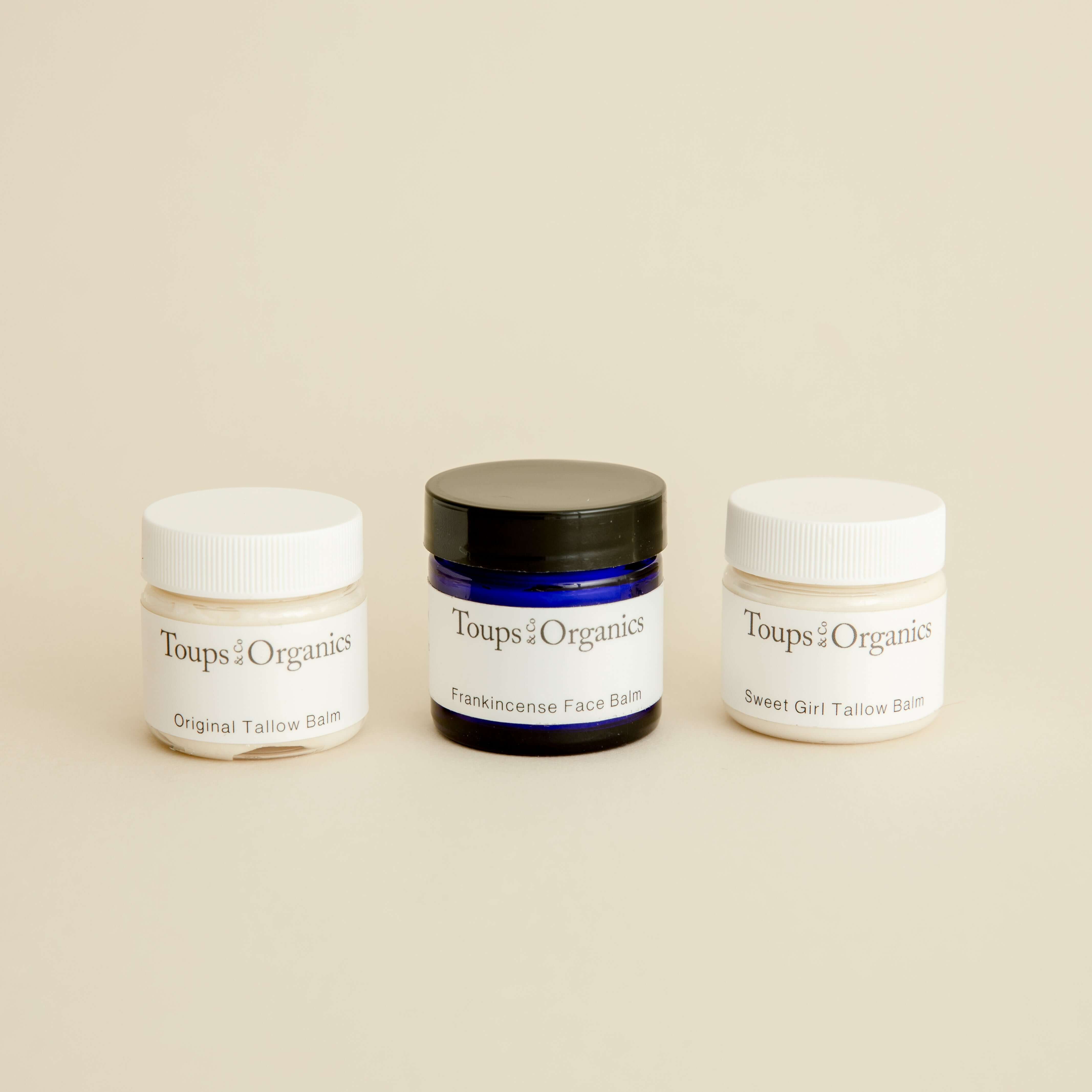 three-mini-tallow-balm-jars-displayed-with-beige-background