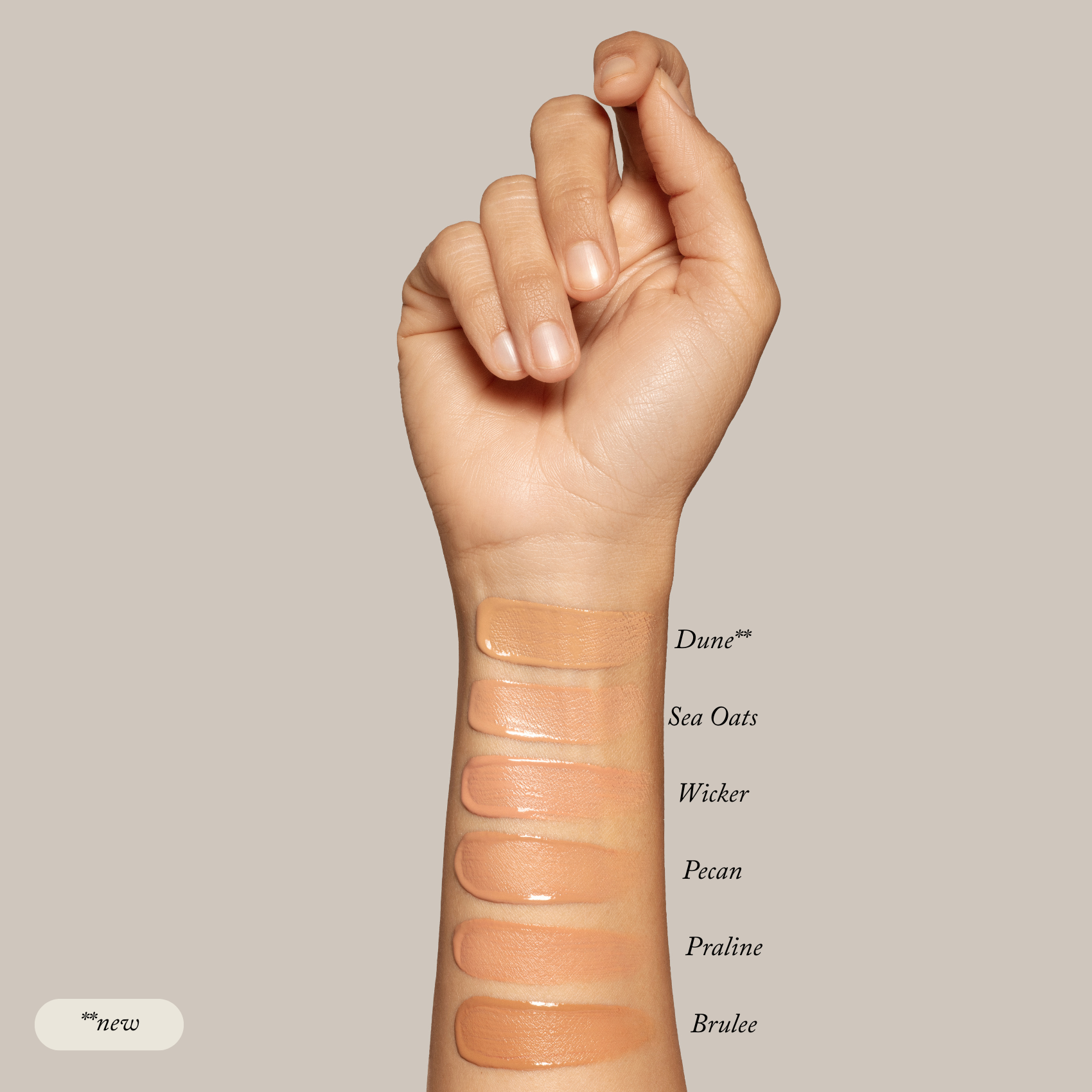 A raised arm displays six swatches—Dune, Sea Oats, Wicker, Pecan, Praline, and Brulee—from the Toups and Co Organics Sample Set - Liquid Foundation. Ideal for discovering your perfect match in this foundation sample kit.