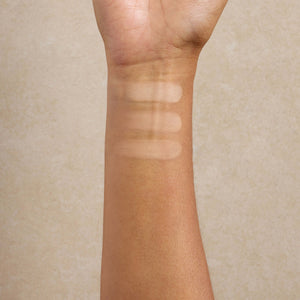 woman-displays-medium-shade-swatches-of-mineral-makeup-on-her-arm
