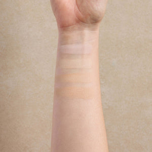woman-displays-light-shade-swatches-of-mineral-makeup-on-her-arm