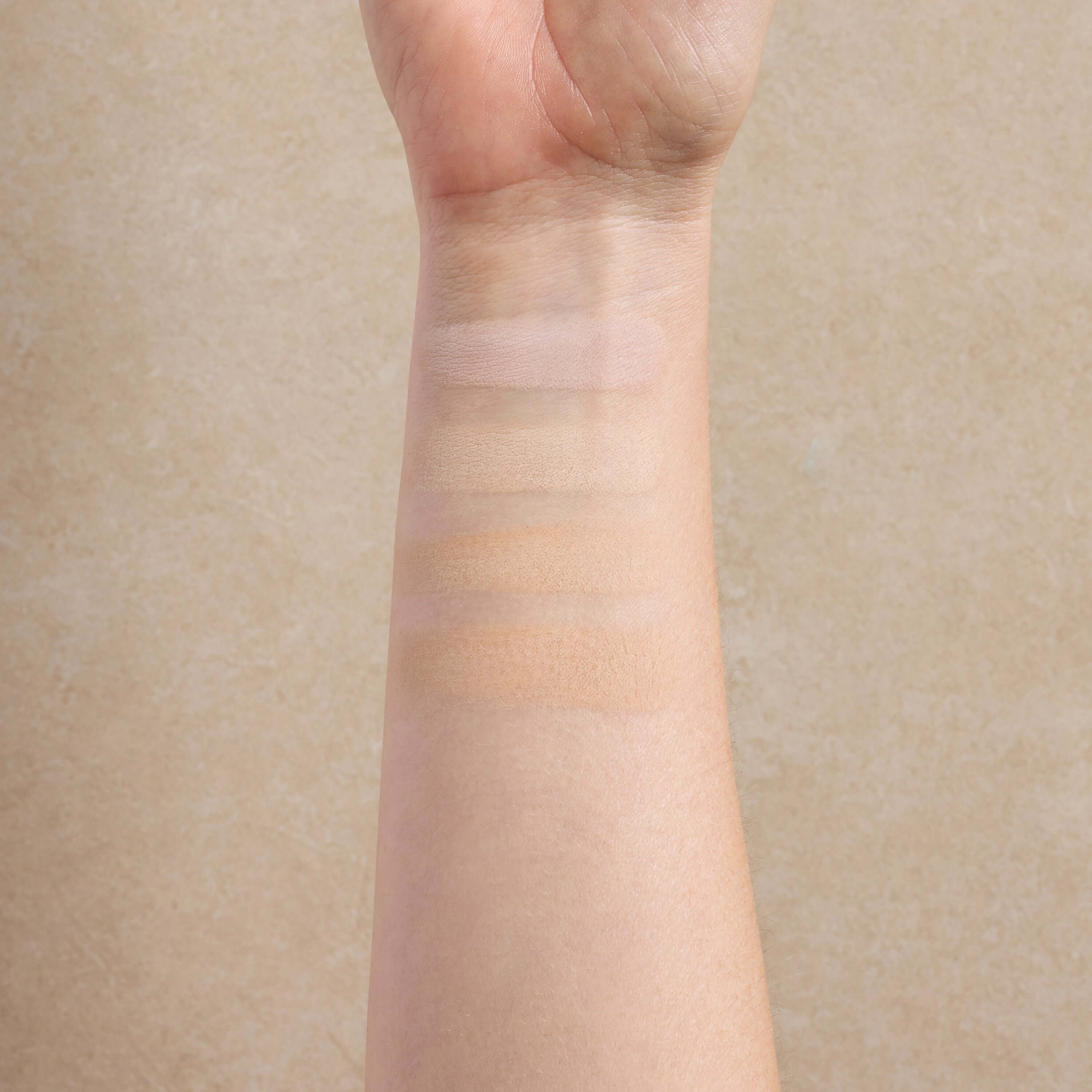 woman-displays-light-shade-swatches-of-mineral-makeup-on-her-arm