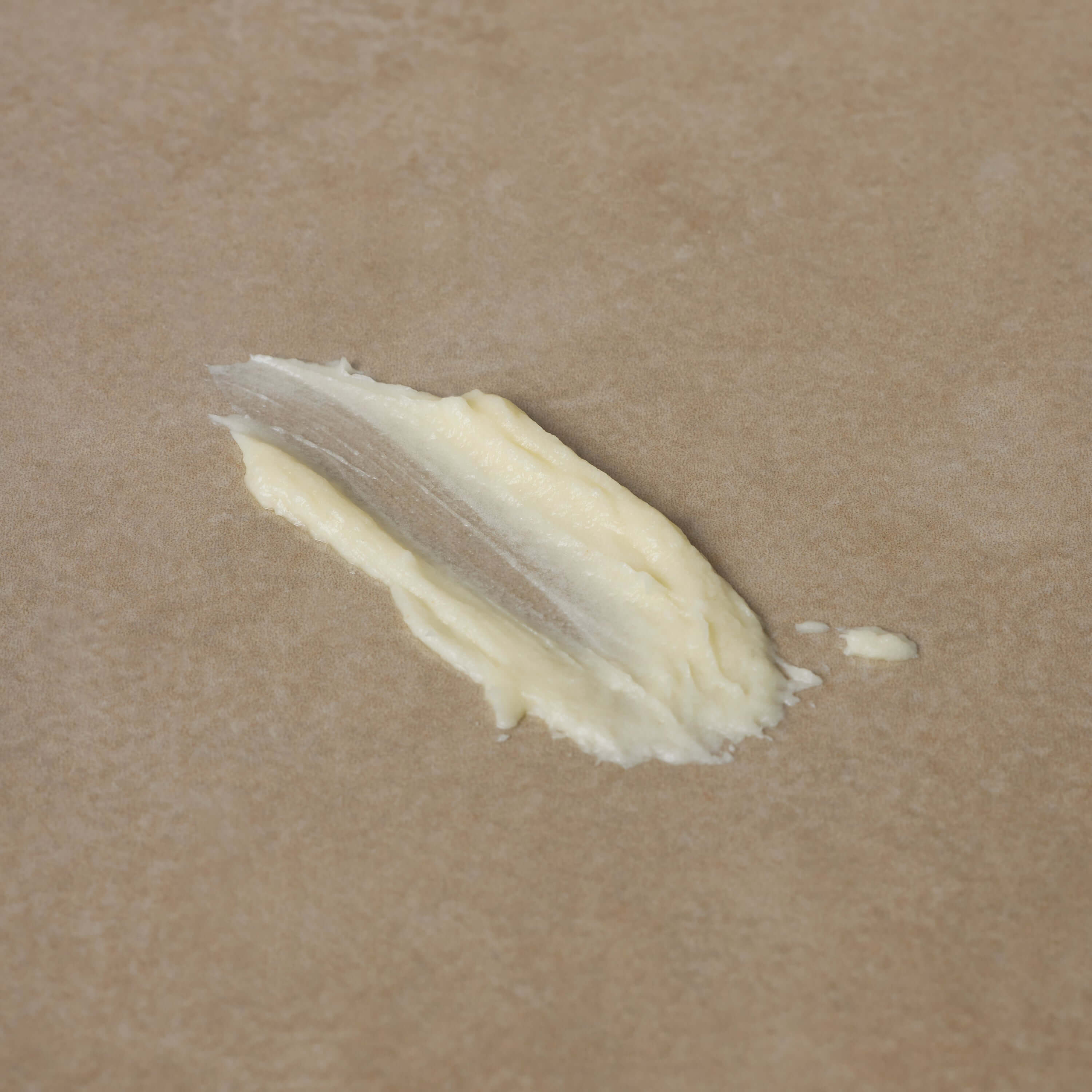 textured-photo-of-tallow-balm-against-brown-surface