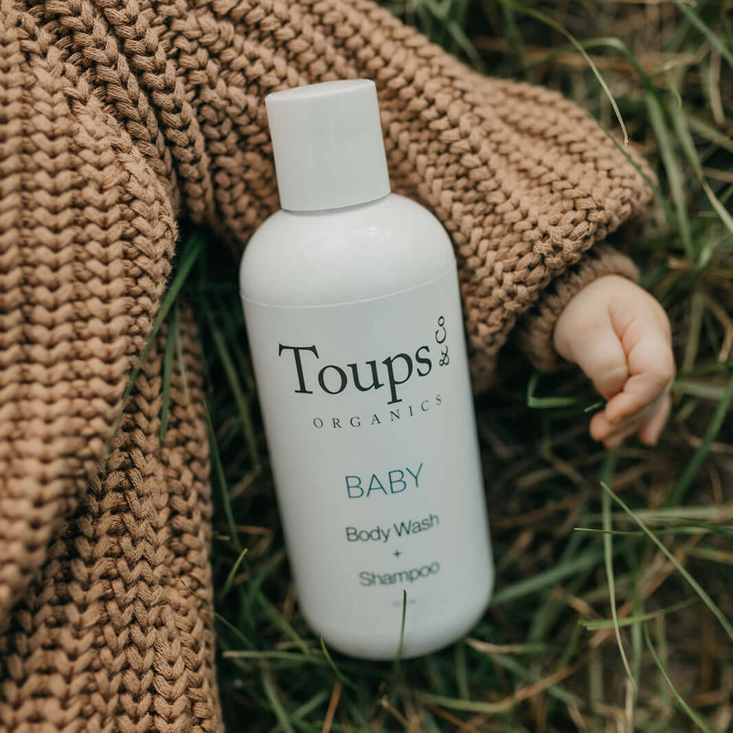 cute-baby-holds-bottle-of-nontoxic-body-wash-for-babies
