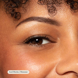 Close-up of an eye, eyebrow, and cheek with smooth, glowing skin wearing Toups and Co Organics Natural Eyeshadow Single in “Iced Mocha | Shimmer.”.