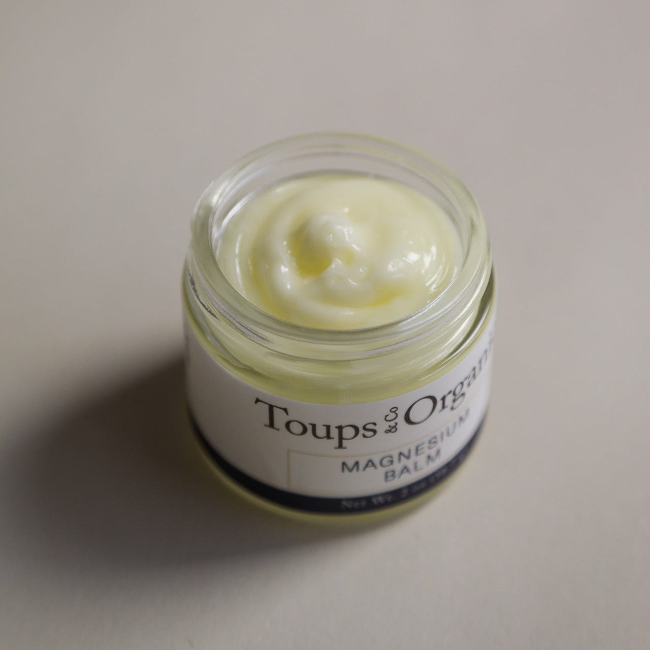 Jar of Toups & Co magnesium balm on a light background