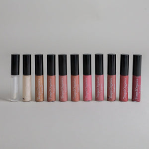 Full shade lineup of non-toxic Toups & Co lip gloss, eleven shades in a row